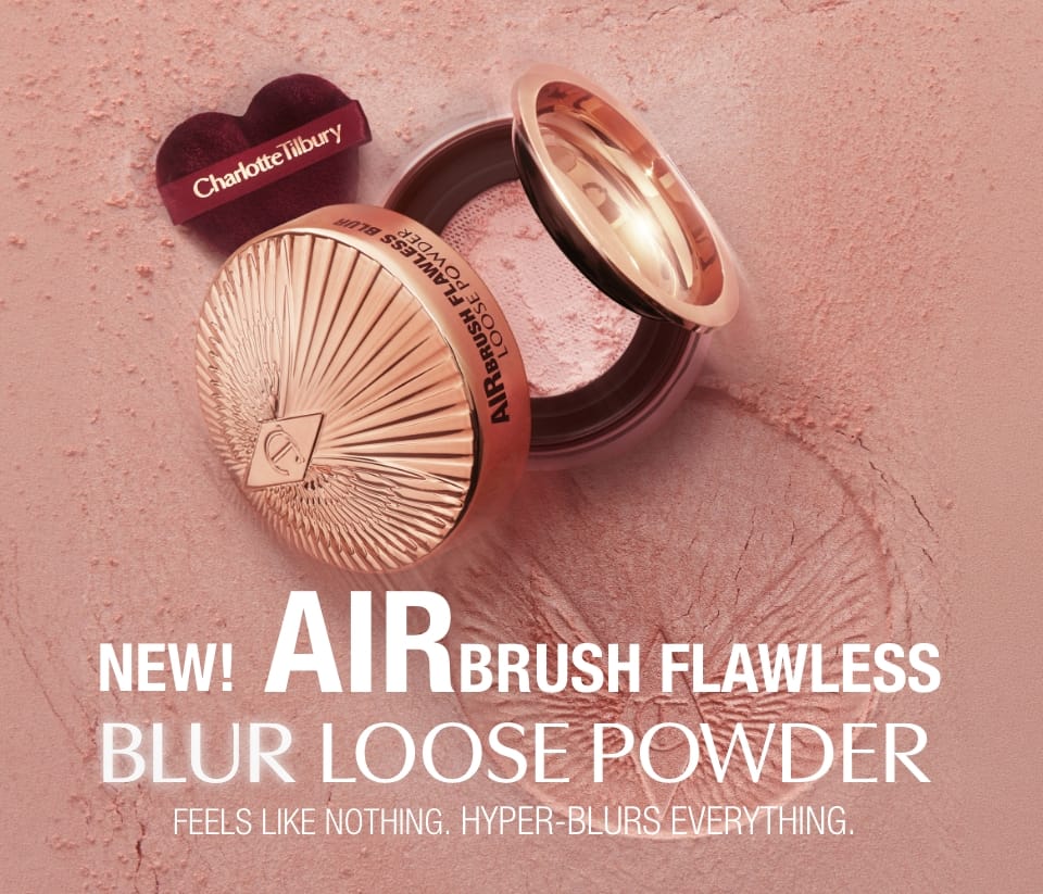 Charlotte Tilbury Airbrush Flawless Blur Loose Powder in a rose gold compact, shown open with its heart-shaped branded lid resting on top, set against a textured pink powder background with promotional text.